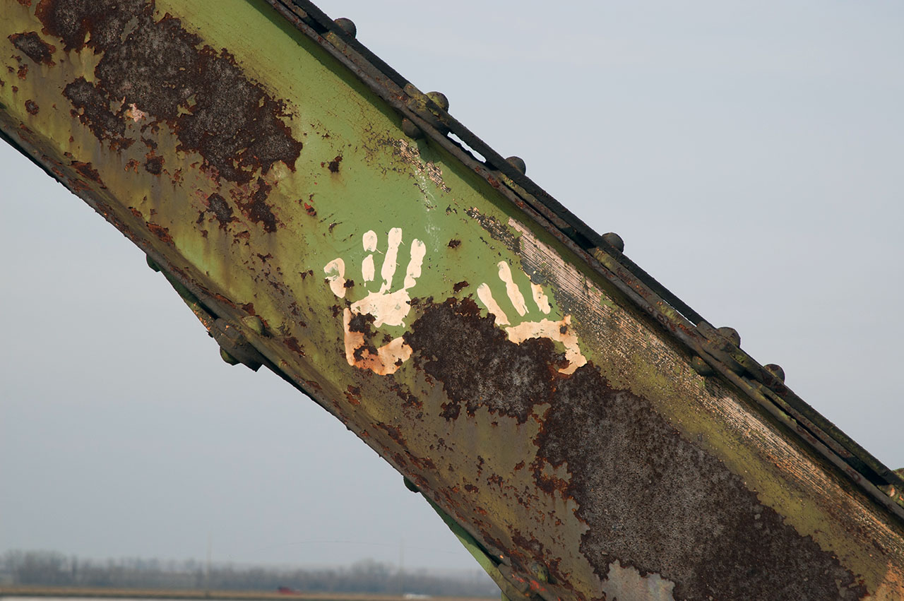 Prints of hands on rusted steel girder
