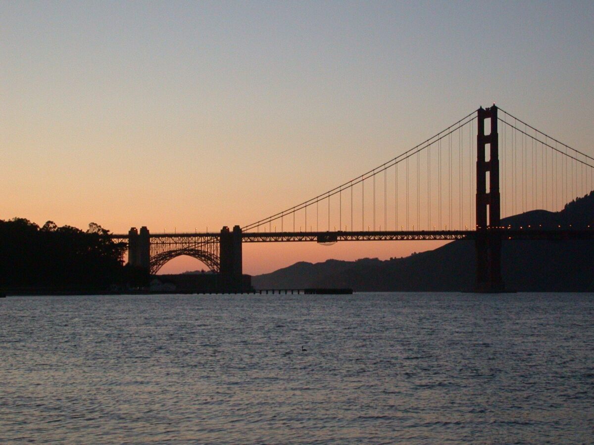 Golden Gate bridge silhouette against warm sunset