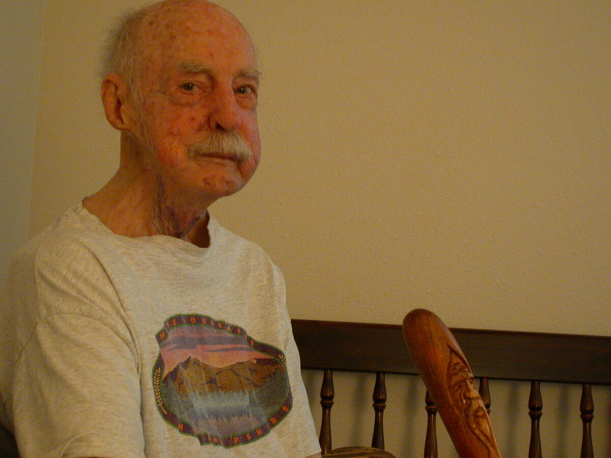 My Dad shortly before he died, wearing a t-shirt and holding his favorite carved wood cane