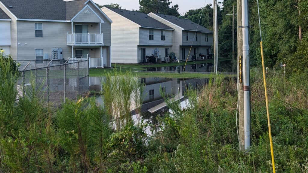 Town houses from the back, with flood waters very close