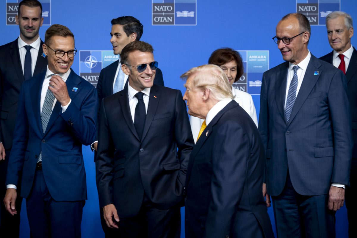 NATO photo of leaders with Trump walking in front of them.